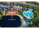 Aerial view of a community center featuring a pool and beach with a pier extending onto the lake at 10534 Bermuda Isle Dr, Tampa, FL 33647