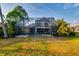 A well-maintained lawn featuring a screened-in pool and landscaping at 10534 Bermuda Isle Dr, Tampa, FL 33647