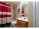 Cozy bathroom featuring a shower-tub combo, tile walls and a neutral-colored vanity at 10534 Bermuda Isle Dr, Tampa, FL 33647