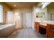 Bright bathroom featuring a soaking tub, glass shower, and double sink vanity at 10534 Bermuda Isle Dr, Tampa, FL 33647