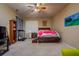 Comfortable bedroom with ceiling fan, carpet and natural light from a large window at 10534 Bermuda Isle Dr, Tampa, FL 33647