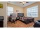 Cozy bedroom with hardwood floors, a large window and a dark wood bed at 10534 Bermuda Isle Dr, Tampa, FL 33647