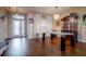 Elegant dining room with hardwood floors, modern lighting, and a glass-top dining table at 10534 Bermuda Isle Dr, Tampa, FL 33647