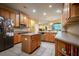 Spacious kitchen with light wood cabinets, an island, and tile flooring at 10534 Bermuda Isle Dr, Tampa, FL 33647