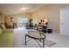 Spacious living room with vaulted ceiling, large TV, modern furniture, and sliding doors at 10534 Bermuda Isle Dr, Tampa, FL 33647