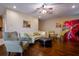 Bright living room with hardwood floors, ceiling fan, and comfortable seating at 10534 Bermuda Isle Dr, Tampa, FL 33647