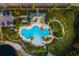 Aerial view of a community pool featuring a large pool area with a clubhouse and lounge chairs at 10534 Bermuda Isle Dr, Tampa, FL 33647