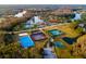 Aerial view of multiple tennis and basketball courts, plus a sand volleyball court, in a community setting at 10534 Bermuda Isle Dr, Tampa, FL 33647