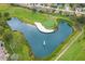Aerial view of a pristine golf course with a water hazard, sand trap, and manicured green at 11138 Brooklawn Dr, Hudson, FL 34667