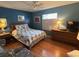 Bright bedroom with wood floors, ceiling fan, and a large window at 11138 Brooklawn Dr, Hudson, FL 34667