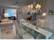 Bright dining room with a glass table, chandelier, and adjoining living space at 11138 Brooklawn Dr, Hudson, FL 34667
