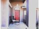 Charming front entryway with a red door and a decorative porch with seating at 11138 Brooklawn Dr, Hudson, FL 34667