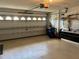 Clean and spacious garage with a modern door, storage cabinets, and ample space at 11138 Brooklawn Dr, Hudson, FL 34667