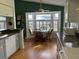 Bright kitchen with a dining table, white cabinets, stainless steel appliances, and large windows at 11138 Brooklawn Dr, Hudson, FL 34667