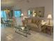 Cozy living room featuring neutral decor, tile flooring, and adjacent dining area at 11138 Brooklawn Dr, Hudson, FL 34667