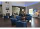 Inviting lounge area with comfortable seating, fireplace, artwork, and natural light at 11138 Brooklawn Dr, Hudson, FL 34667
