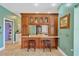 Open dining area with breakfast bar seating featuring wooden cabinetry and tile flooring at 11209 Bloomington Dr, Tampa, FL 33635