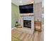 Living room brick fireplace with mantel, hearth, and mounted television at 11209 Bloomington Dr, Tampa, FL 33635