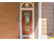 Inviting front door with decorative wreath, stained glass, and welcome mat at 11209 Bloomington Dr, Tampa, FL 33635