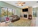 Inviting living room with a brick fireplace, a ceiling fan, and a sliding glass door with a view of the pool at 11209 Bloomington Dr, Tampa, FL 33635