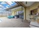 Covered patio featuring a grill, seating area, outdoor bar, and view of the backyard at 11209 Bloomington Dr, Tampa, FL 33635