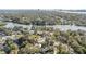 Beautiful aerial view of the neighborhood, showcasing its proximity to a tranquil waterway and surrounded by mature trees at 1157 Brook Rd, Clearwater, FL 33755