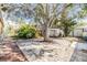 Landscaped backyard with a deck and mature trees at 1157 Brook Rd, Clearwater, FL 33755