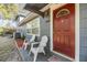 Inviting front porch area with seating, offering a cozy spot to relax and enjoy the neighborhood at 1157 Brook Rd, Clearwater, FL 33755
