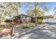 Well-maintained property with a landscaped front yard and covered parking at 1157 Brook Rd, Clearwater, FL 33755