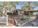 Landscaped front yard with mature trees and brick-lined walkway at 1157 Brook Rd, Clearwater, FL 33755