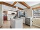 Modern kitchen featuring white cabinets, stainless steel appliances, and a center island for food preparation at 1157 Brook Rd, Clearwater, FL 33755
