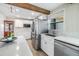 Well-lit kitchen boasting a large stainless steel refrigerator, white cabinets, and modern appliances at 1157 Brook Rd, Clearwater, FL 33755