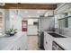 Bright kitchen featuring white cabinets, quartz countertops, stainless steel appliances, and a central island at 1157 Brook Rd, Clearwater, FL 33755