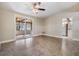Bright living space featuring a ceiling fan and sliding door access to the outdoor patio area at 1157 Brook Rd, Clearwater, FL 33755