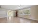 Open-concept living area with tile floors, neutral walls, and large windows for natural light at 1157 Brook Rd, Clearwater, FL 33755
