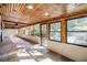 Enclosed sunroom with wood ceiling and natural lighting at 1157 Brook Rd, Clearwater, FL 33755