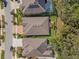 Aerial view of a house and neighborhood with beautiful landscaping and a screened-in pool at 13711 Moonstone Canyon Dr, Riverview, FL 33579