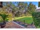 Beautifully landscaped back yard with stone and brick accents, and mature trees at 13711 Moonstone Canyon Dr, Riverview, FL 33579