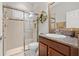 A clean bathroom featuring a glass-enclosed shower and granite vanity at 13711 Moonstone Canyon Dr, Riverview, FL 33579