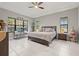 Spacious bedroom with a large bed, tile flooring, and a window seating area overlooking the outside at 13711 Moonstone Canyon Dr, Riverview, FL 33579