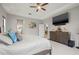 Bedroom with a dresser, flat screen TV, neutral color palette, and an ensuite bathroom at 13711 Moonstone Canyon Dr, Riverview, FL 33579