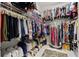 Walk-in closet with clothing racks, shelving, and a patterned rug on the tile floor at 13711 Moonstone Canyon Dr, Riverview, FL 33579