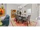 Open dining area with a glass table, six chairs, and a china cabinet with a decorative rug at 13711 Moonstone Canyon Dr, Riverview, FL 33579