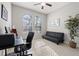 Well-lit home office with a futon, desk, and large windows at 13711 Moonstone Canyon Dr, Riverview, FL 33579