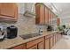 Modern kitchen featuring granite counters, tile backsplash, sleek appliances, and beautiful cabinetry at 13711 Moonstone Canyon Dr, Riverview, FL 33579