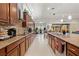 Open kitchen with stainless steel appliances, granite countertops, and a view into the living space at 13711 Moonstone Canyon Dr, Riverview, FL 33579