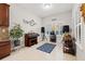 Bright, inviting living space with tile floors, piano, speakers, and mini-bar perfect for entertaining at 13711 Moonstone Canyon Dr, Riverview, FL 33579