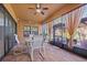 Screened outdoor patio with ceiling fan, furniture, and view of backyard at 13711 Moonstone Canyon Dr, Riverview, FL 33579