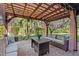 Covered outdoor patio with ceiling lights, comfortable seating, and view of landscaped yard at 13711 Moonstone Canyon Dr, Riverview, FL 33579