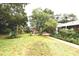 View of the backyard featuring mature trees and patio set at 1372 Palmetto St, Clearwater, FL 33755